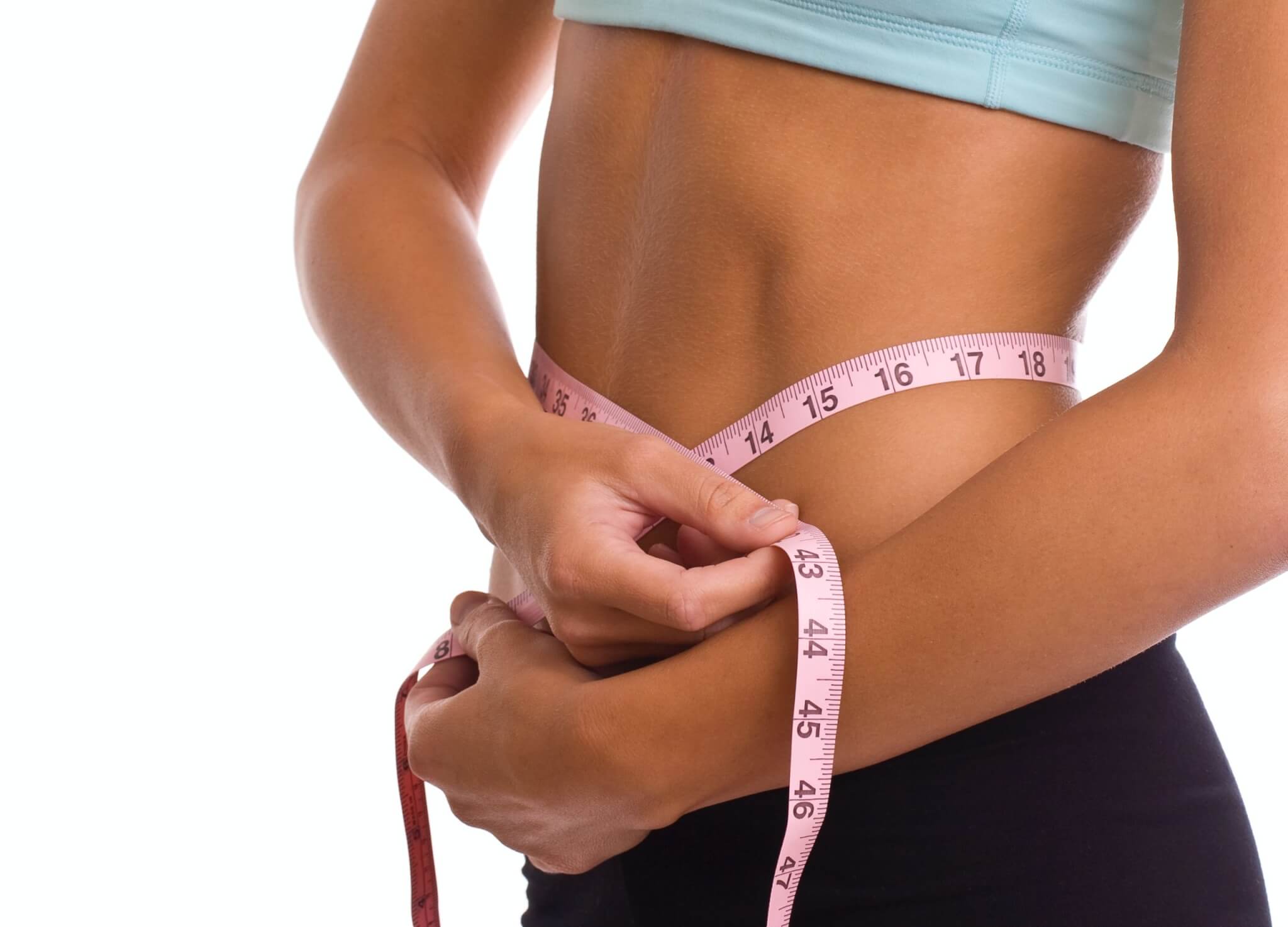 Weight loss: woman measuring her waist size