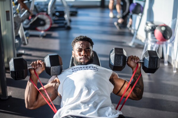 Man lifting weights at gym, working out