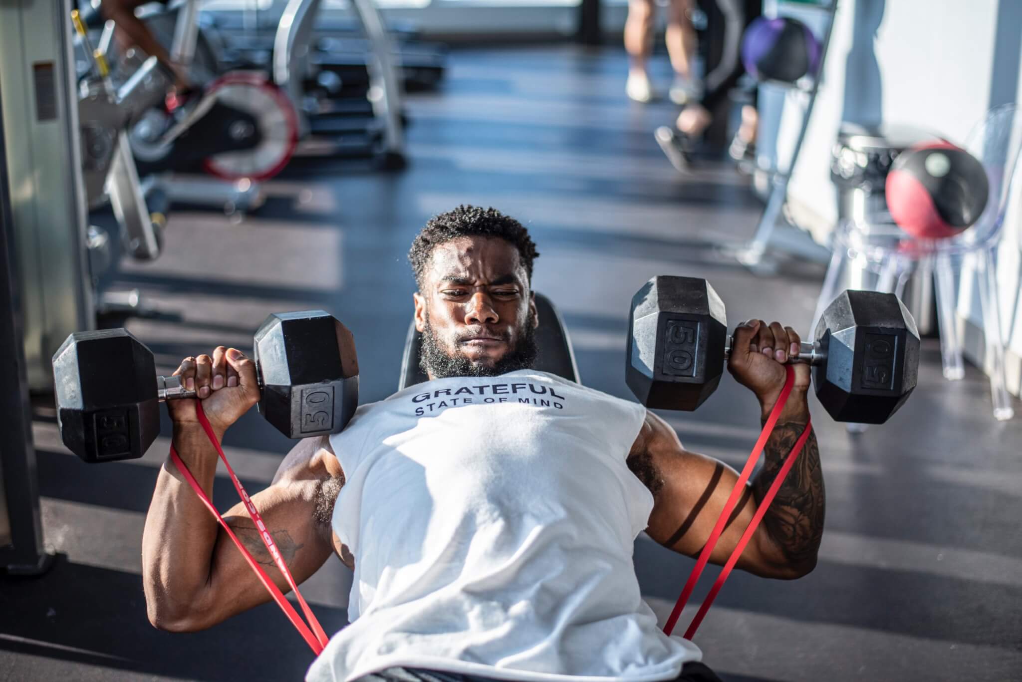 Man lifting weights at gym, working out