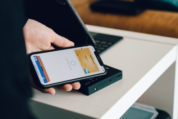 Person using credit cards on Apple Pay to purchase item while shopping