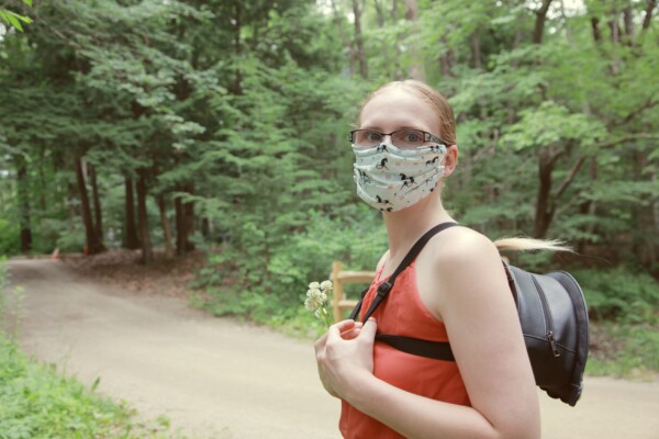Woman wearing face mask during nature walk