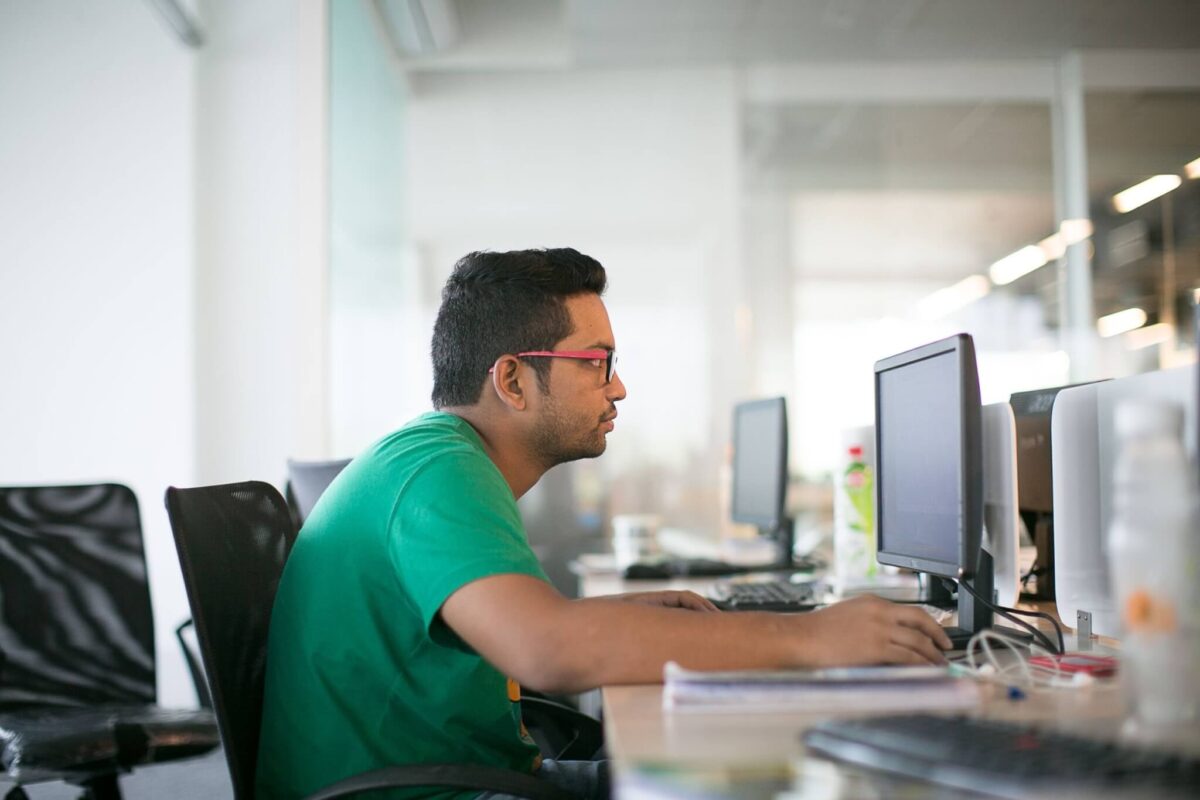 man sitting at computer