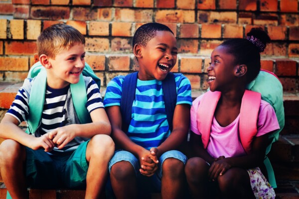 Happy children laughing, talking at school