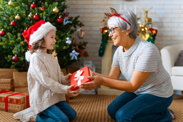 Grandma giving granddaughter Christmas or holiday gift