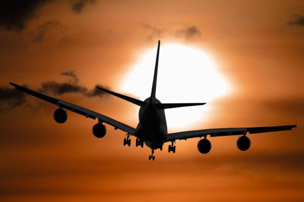 Airplane flying in sunset