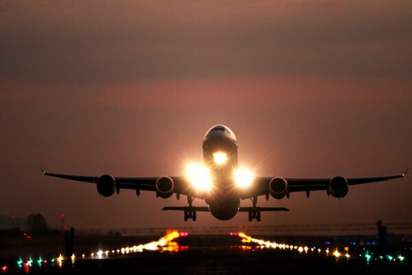 Airplane landing on runway at night