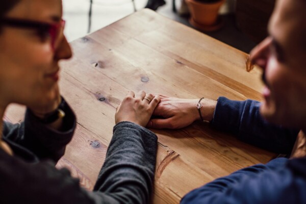 Couple talking, holding hands