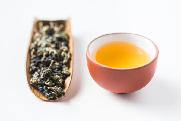 Oolong tea leaves and tea cup.