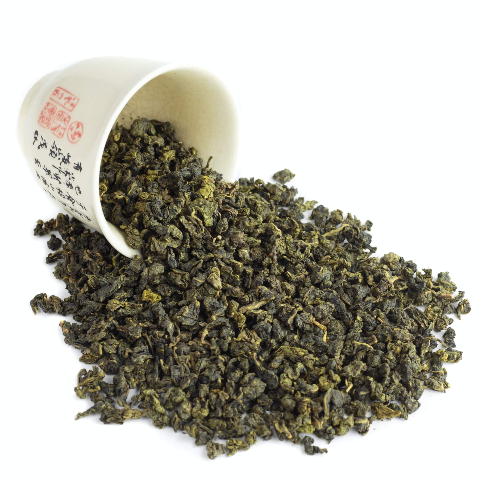 Oolong tea leaves spilled out of cup