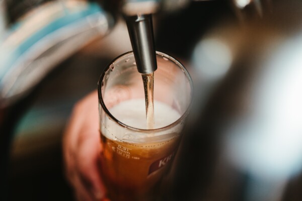 Beer being poured into glass from tap