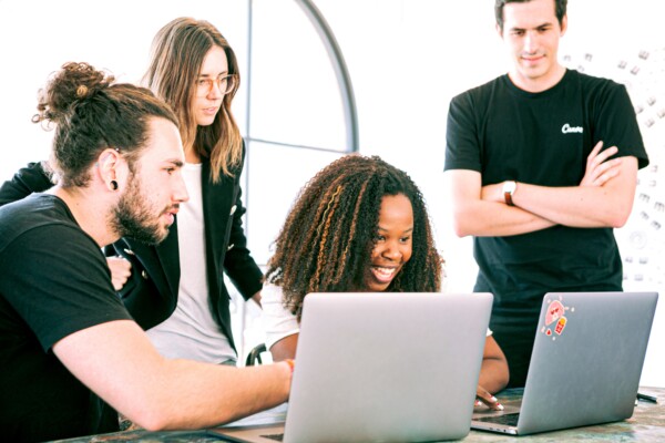 Office meeting, startup employees looking at computers