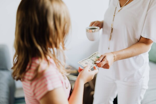 Mother gives child money for allowance
