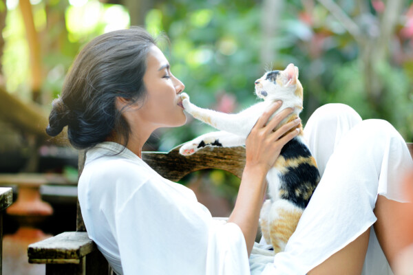 Woman playing with pet cat