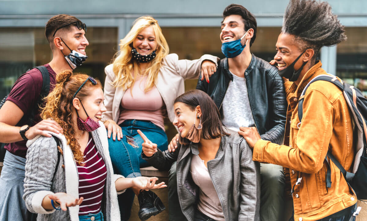 College friends, students hanging out not social distancing with face masks down
