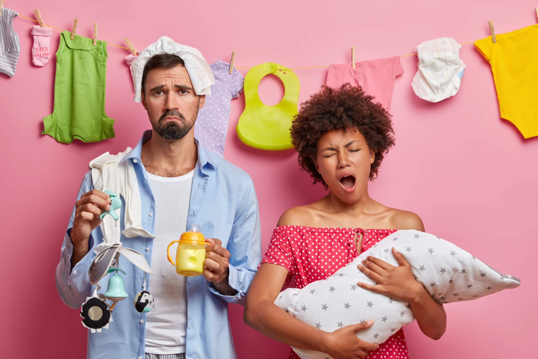 Tired, exhausted parents holding baby