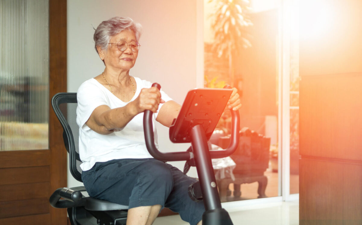 Older woman on stationary exercise bike