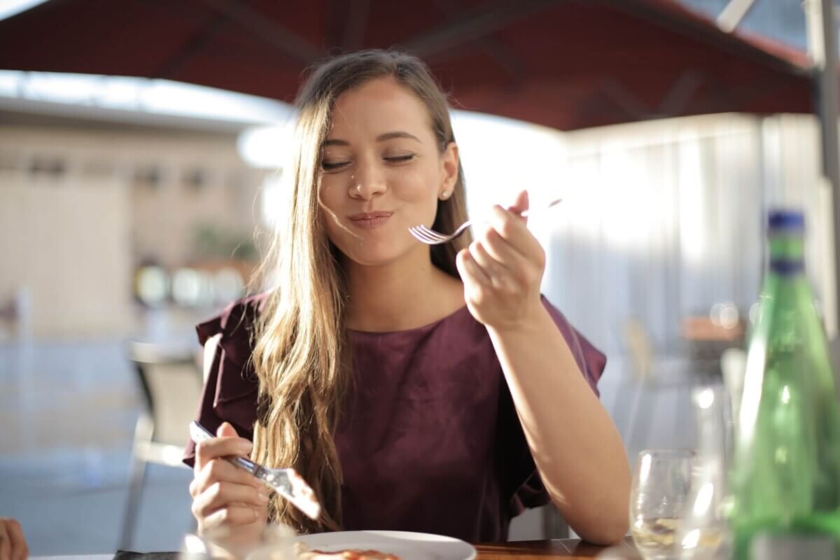 Woman eating food, smiling