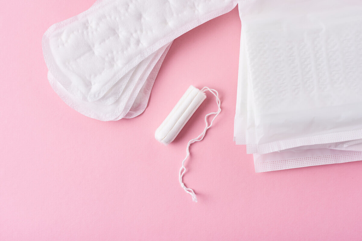 Sanitary pad and menstrual tampon on a pink background