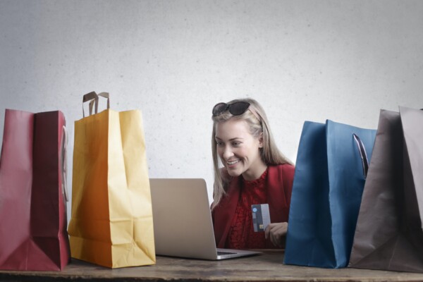 Shopaholic: Woman online shopping with shopping bags