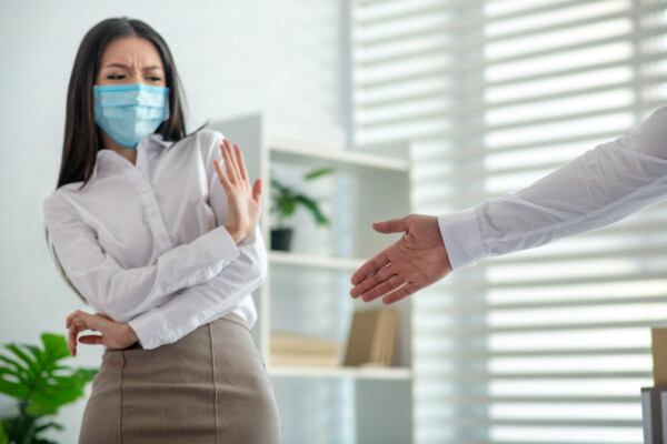 Woman in mask won't shake hand during COVID pandemic