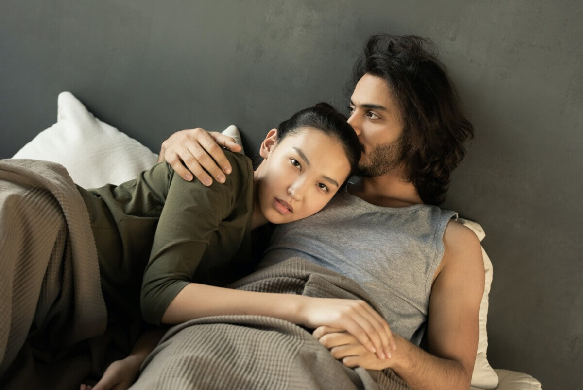 Unhappy couple in bed