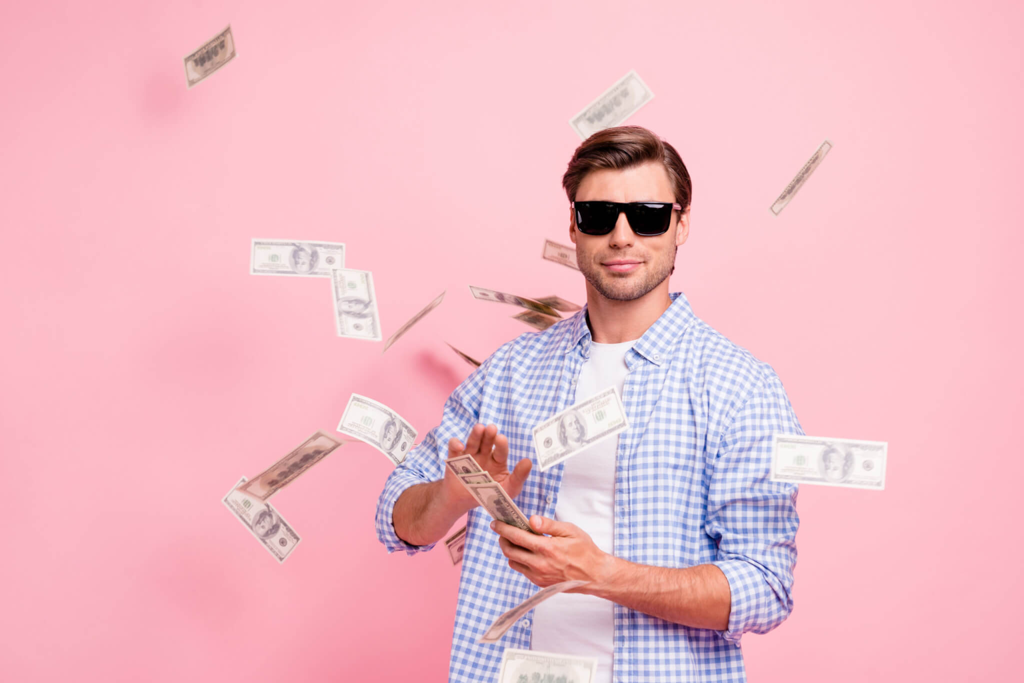 Man throwing money into the air like he's rich