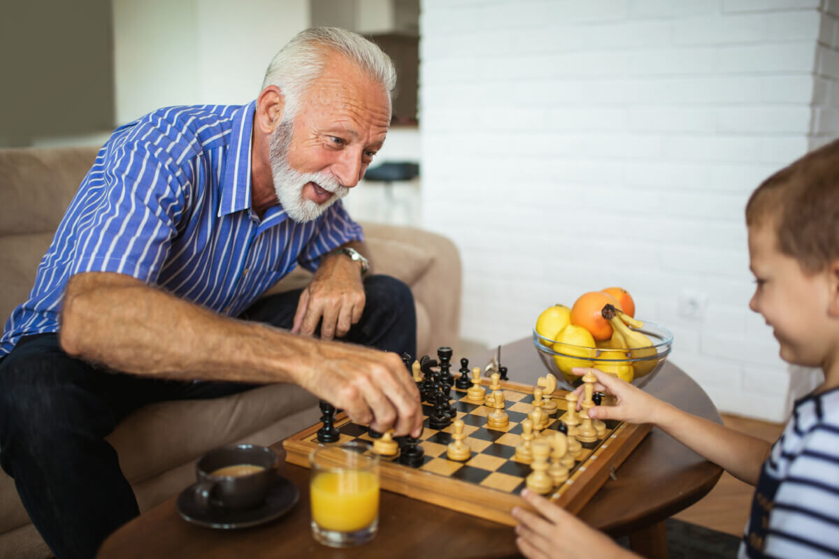 Grandfather playing chess with grandson