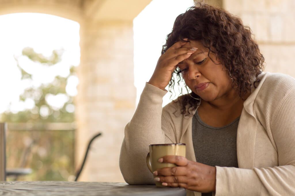 Middle-aged woman feeling sad or depressed, or having menopause symptoms