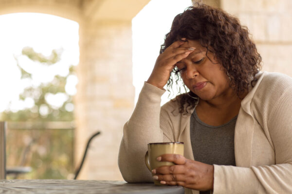 Middle-aged woman feeling sad or depressed, or having menopause symptoms