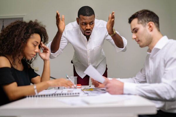 Boss or manager yelling at office workers