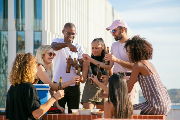 Group of friends drinking beers, toasting