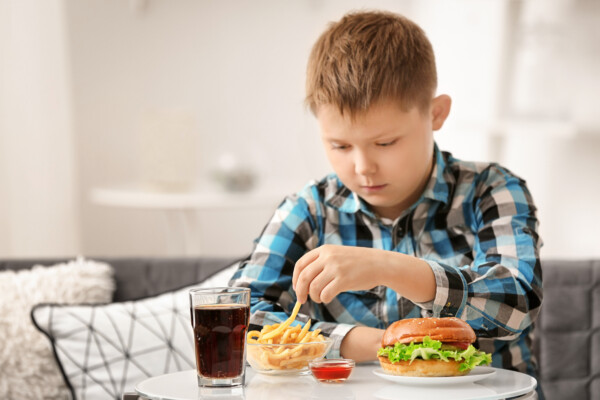 Child eating fast food at home