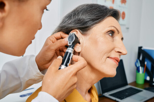 Older woman undergoing hearing test