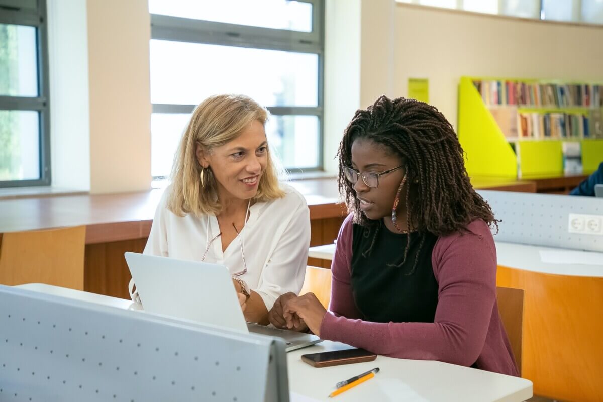 Professor working with college student
