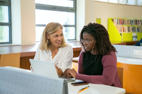 Professor working with college student