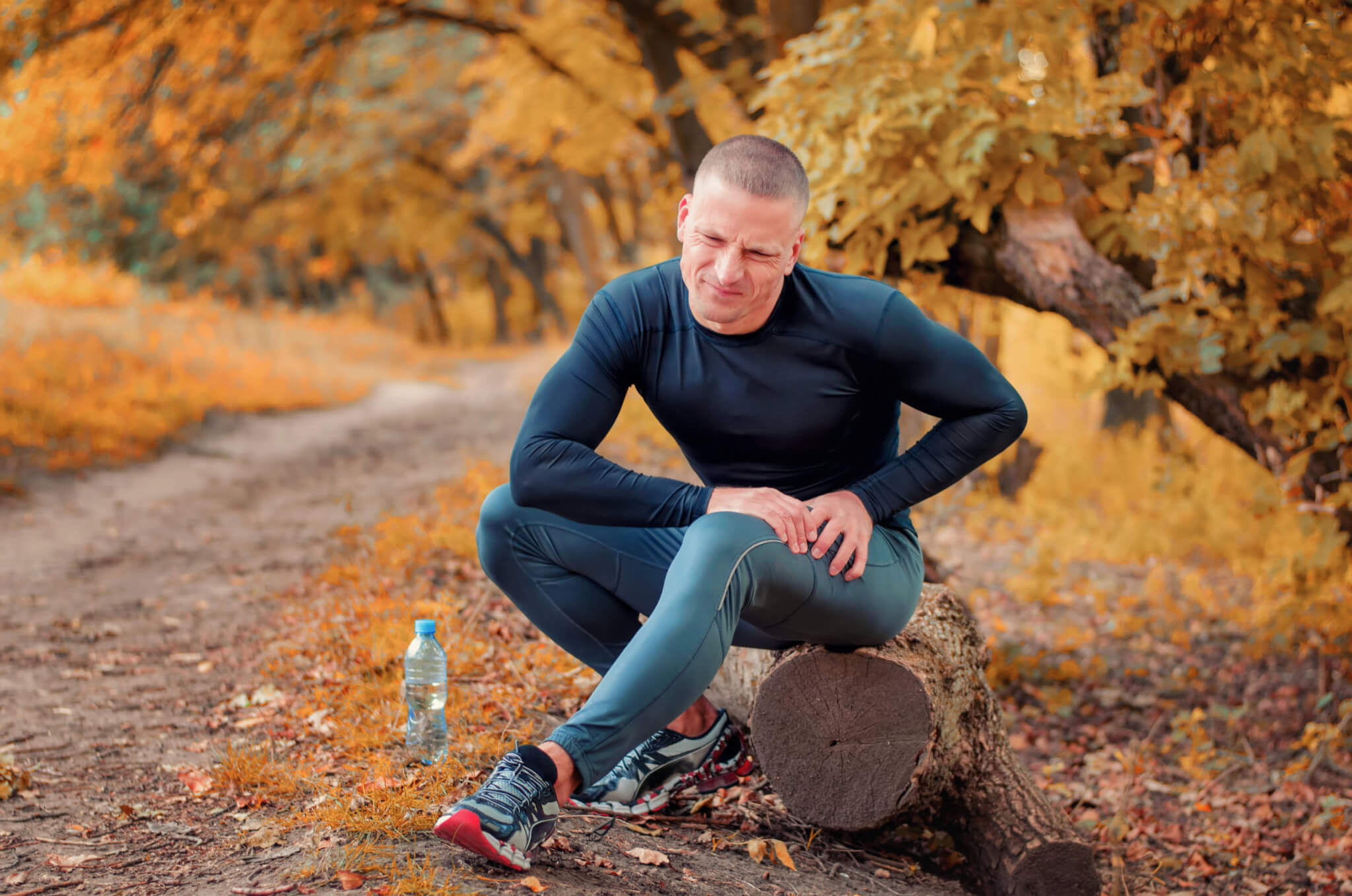 Man suffers leg injury or cramp while running