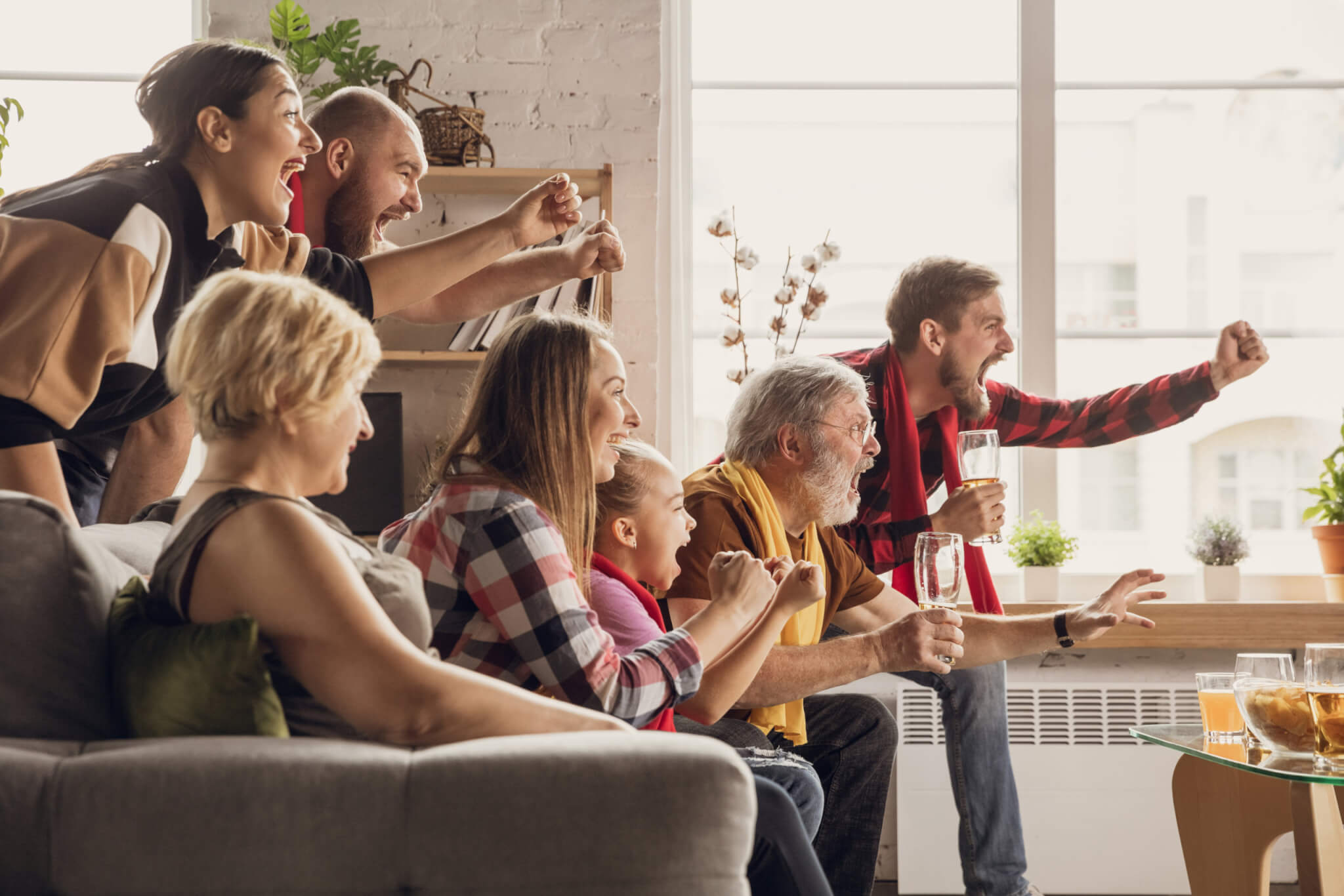 Family watching sports team on TV
