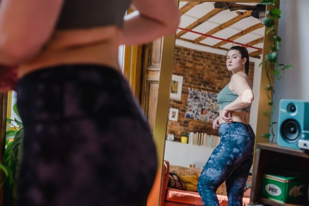 woman looking in mirror
