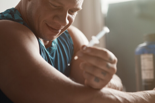 Man making anabolic steroid injection
