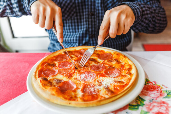 Eating pizza with fork and knife
