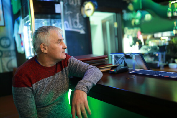 Older man, baby boomer, alone at bar