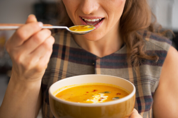 Woman eating soup