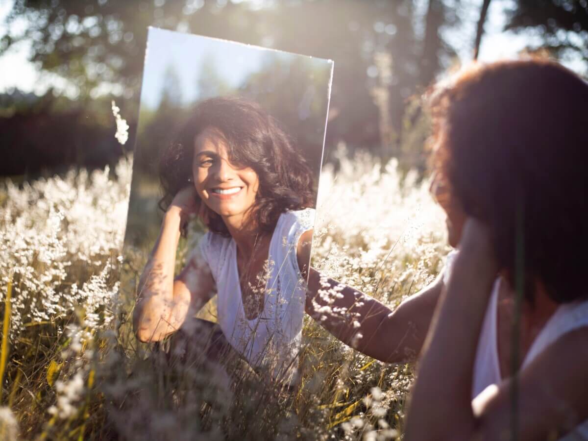 Woman looking in mirror smiling