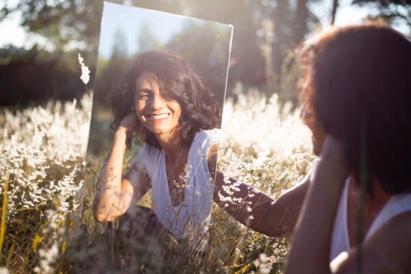 Woman looking in mirror smiling