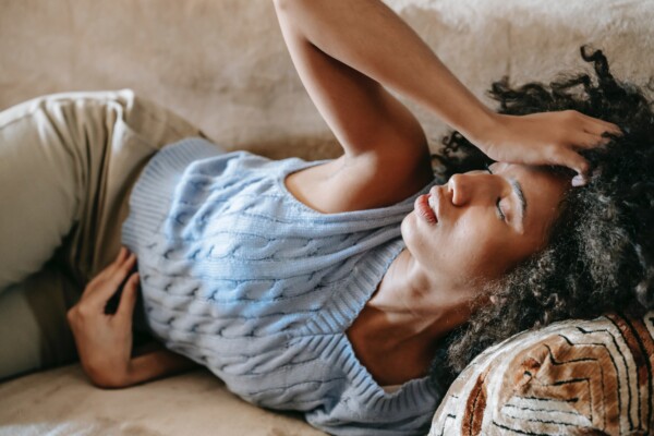 Woman in pain, stomach cramps, feeling sick