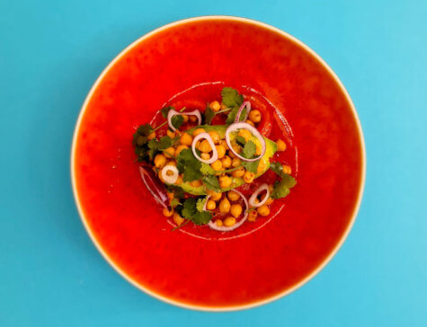 Tomato, avocado and chickpea salad dressed with olive oil.