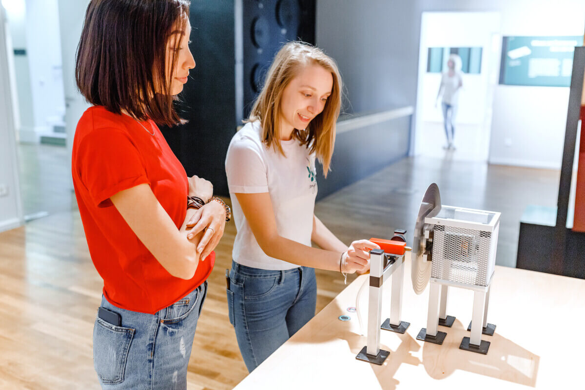Women students making experimental work in the field of mechanics and physics in modern laboratory