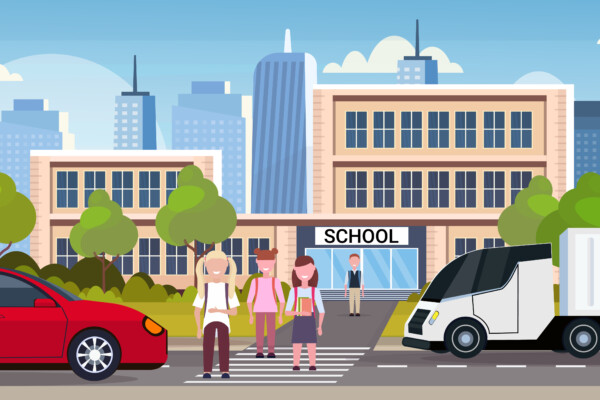 Students crossing crosswalk from busy road outside school