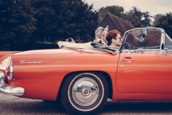 Couple driving vintage car