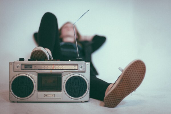 Child or teen listening to music on a boom box